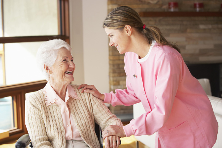 Care worker supporting an older person at home